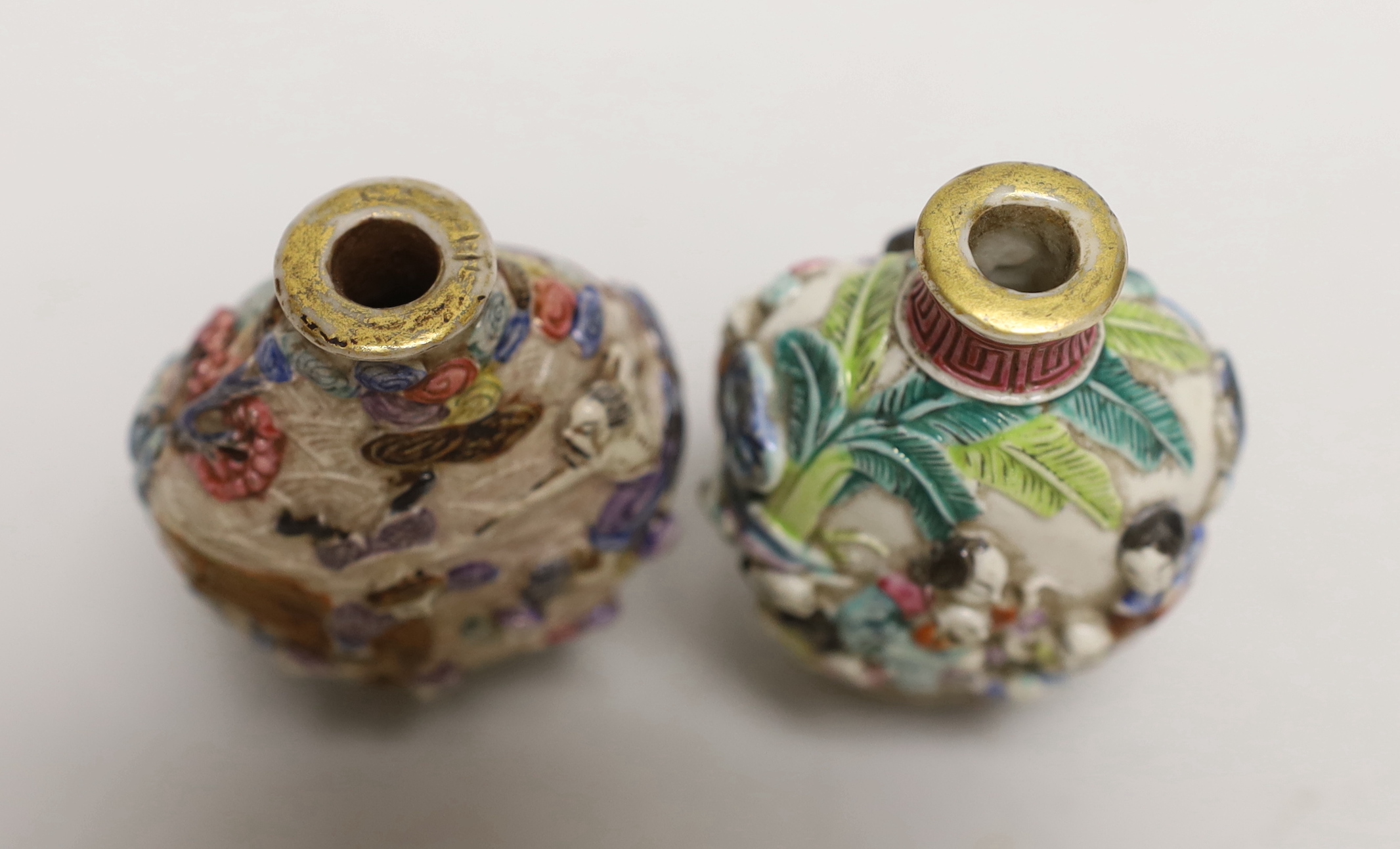 Two Chinese enamelled and moulded porcelain snuff bottles, Qianlong marks but mid 19th century